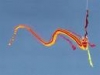 In a colorful kite flying away